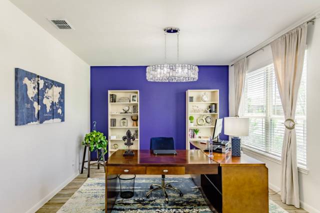 three lightbulbs hanging from the ceiling in front of floating shelves made from wood